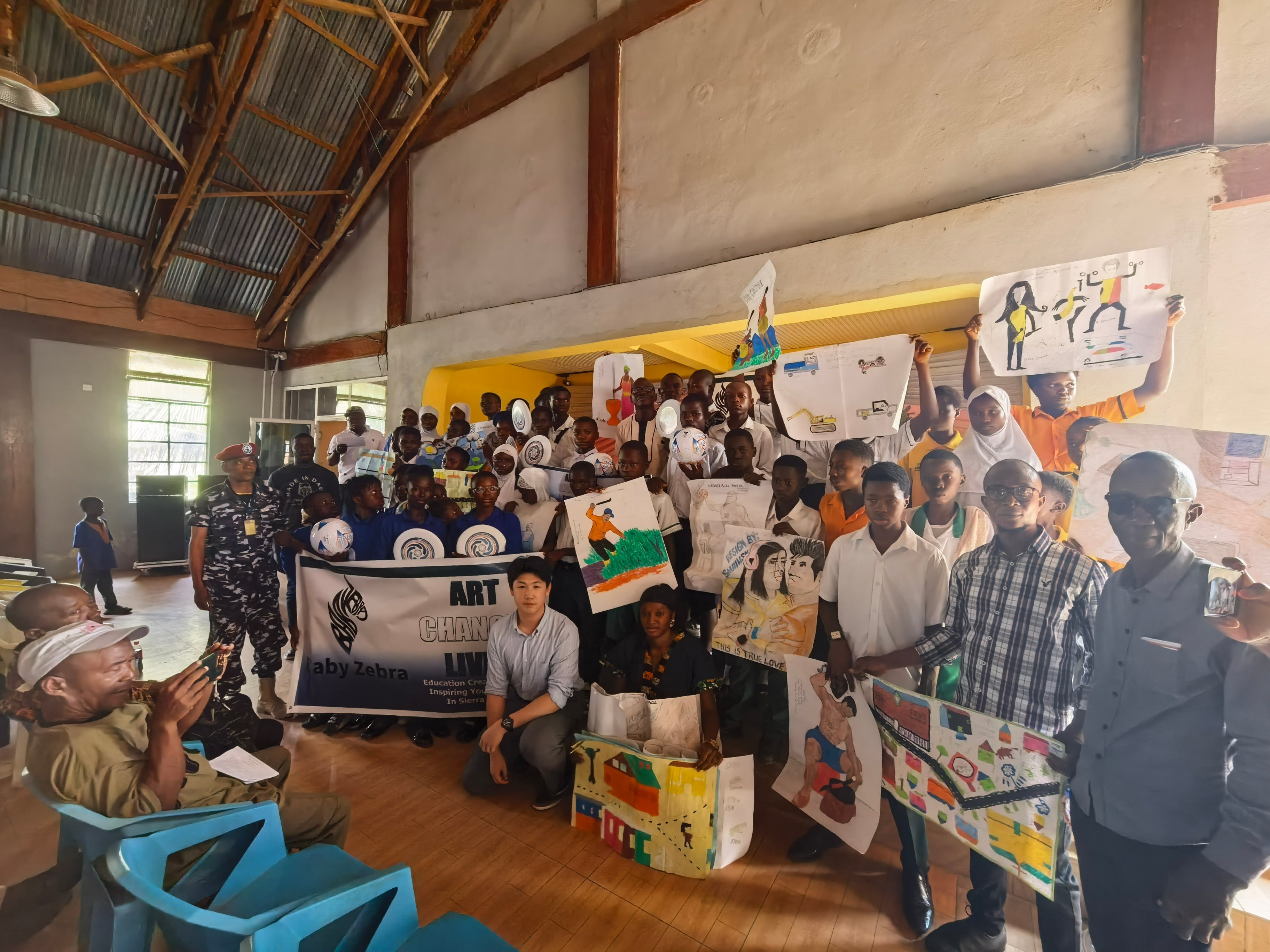 Baby Zebra founder Jacky Chang poses for a group photograph with all students, teachers, staffs and members of the local community.    10 January 2025